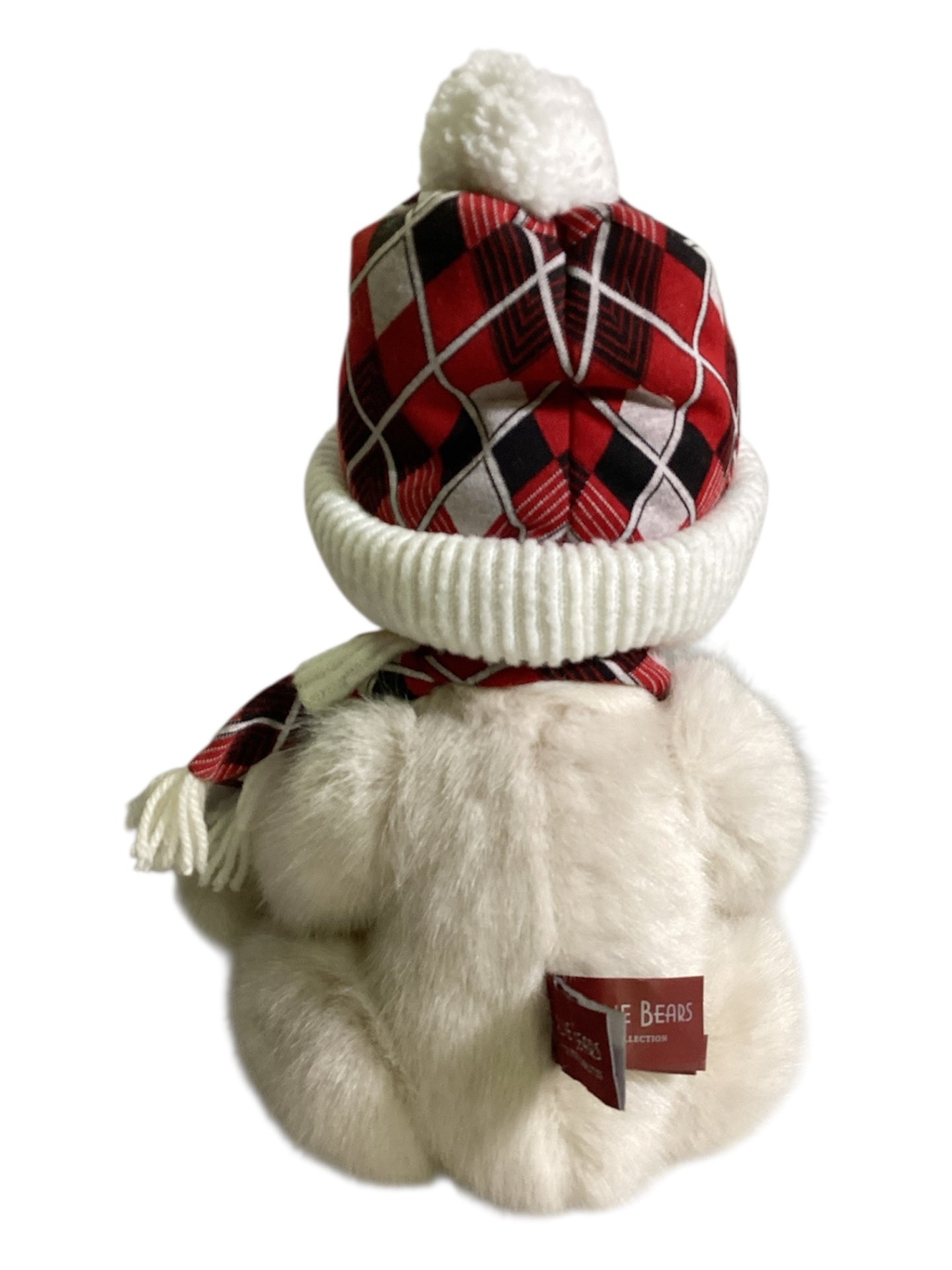 Weißer Teddybär mit Mütze und Schal